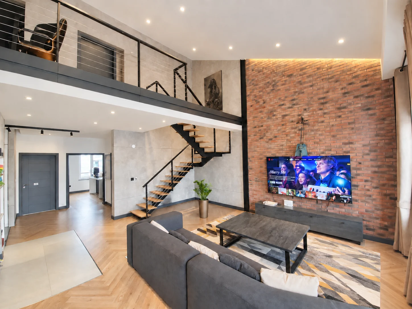 Vestus residential interior — staircase and brick feature wall